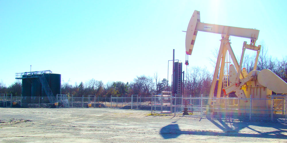 Image of tanks and pump jack from Maximus Operating